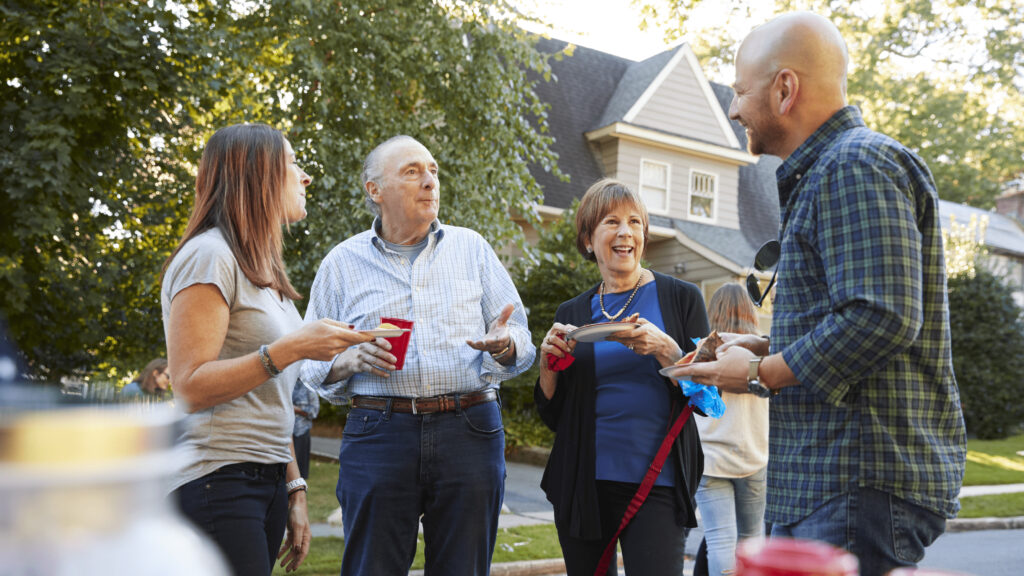 an agent engaging with neighborhood residents at a community gathering